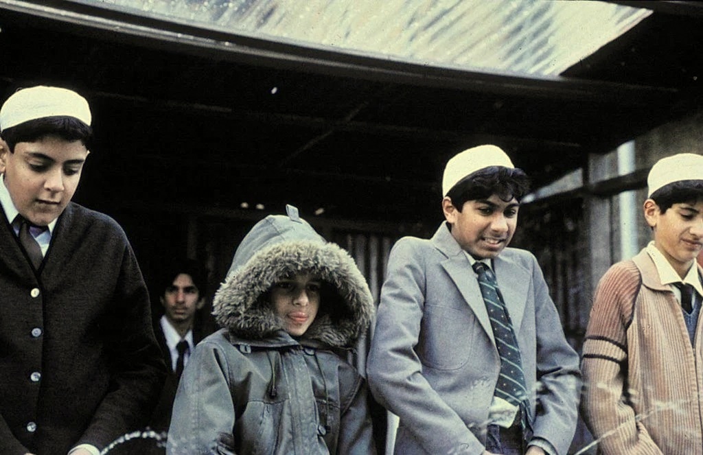 Jordann Routledge 2nd from left in trademark parker in peeing competition with other boys in East is East
